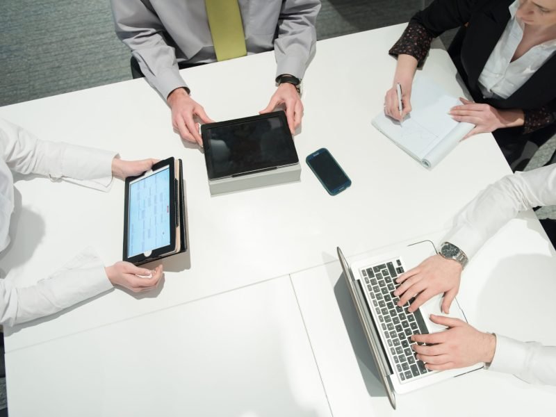 aerial top view  of business people group brainstorming on meeting and businessman presenting ideas and projects on laptop and tablet computer