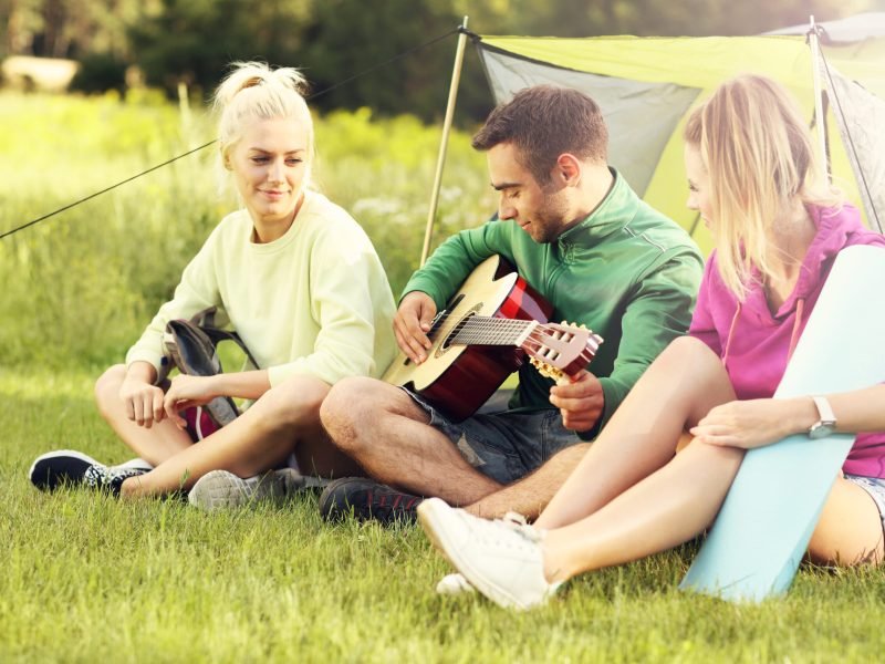 Group of friends camping in forest