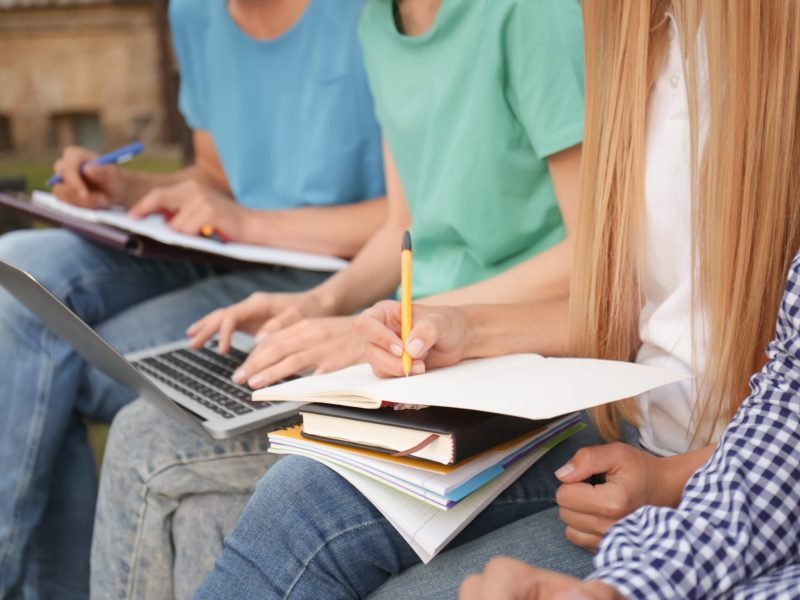 Students studying outdoors, closeup